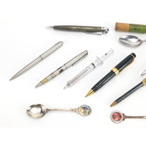 561 - Group of vintage and later pens, including a novelty syringe example and a silver and enamel teaspoo... 