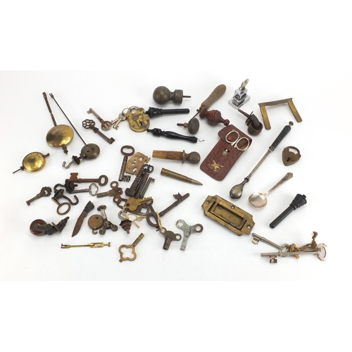 555 - Group of antique and later keys, locks and clock pendulums