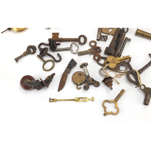 555 - Group of antique and later keys, locks and clock pendulums