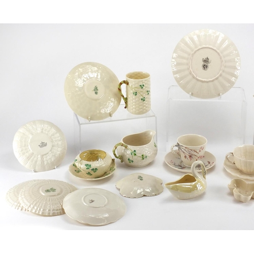 525 - Collection of Belleek porcelain, some early examples including cups, saucers, jug and vases, the lar... 