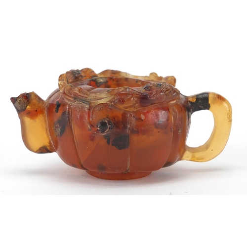 416 - Chinese natural amber teapot decorated with two water dragons, 10cm in length