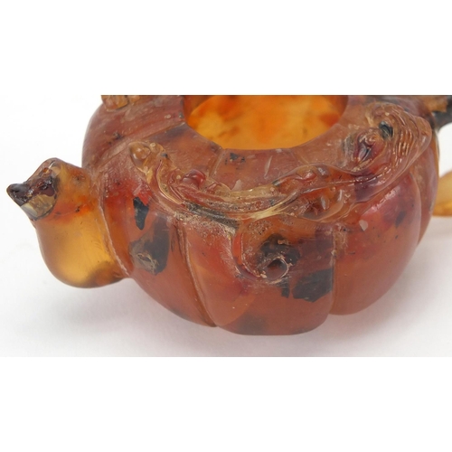 416 - Chinese natural amber teapot decorated with two water dragons, 10cm in length