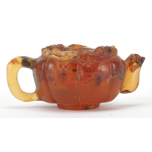 416 - Chinese natural amber teapot decorated with two water dragons, 10cm in length