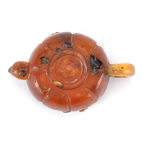 416 - Chinese natural amber teapot decorated with two water dragons, 10cm in length