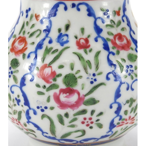 357 - Chinese porcelain strainer, hand painted in the famille rose palette with flowers, 20cm high