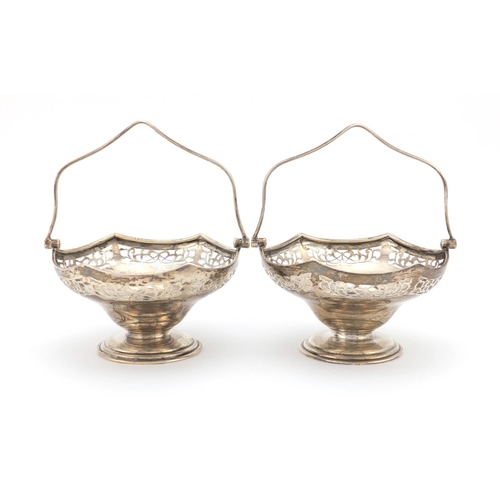 641 - Pair of silver pedestal bon bon dishes with swing handles and pierced decoration, C B & S Sheffield ... 