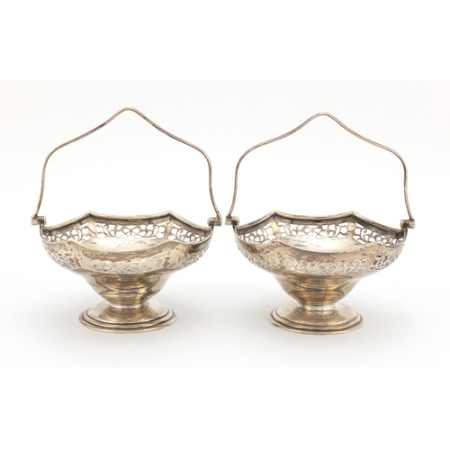 641 - Pair of silver pedestal bon bon dishes with swing handles and pierced decoration, C B & S Sheffield ... 