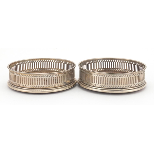 640 - Pair of circular silver and oak wine coasters with pierced decoration, A C & S L D London 1979, 13cm... 