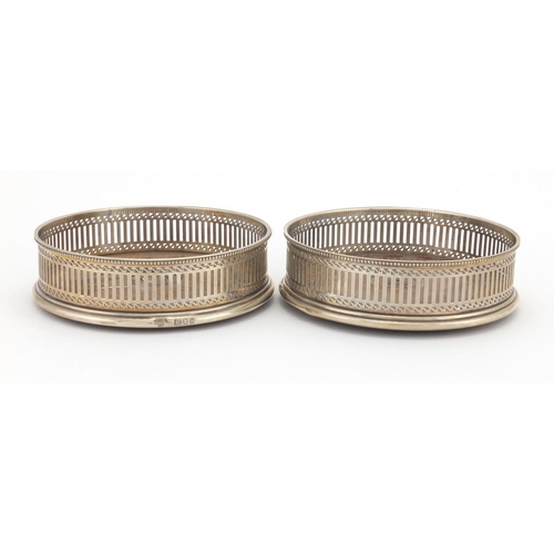 640 - Pair of circular silver and oak wine coasters with pierced decoration, A C & S L D London 1979, 13cm... 