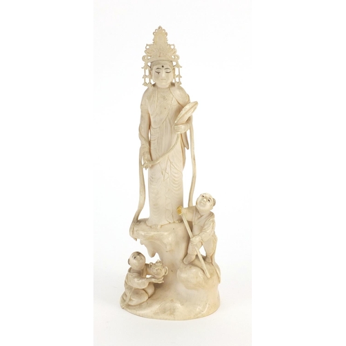 446 - Chinese ivory Okimono carved with a female and two children, red inset character marks to the base, ... 