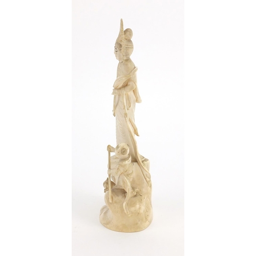 446 - Chinese ivory Okimono carved with a female and two children, red inset character marks to the base, ... 