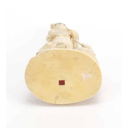 446 - Chinese ivory Okimono carved with a female and two children, red inset character marks to the base, ... 