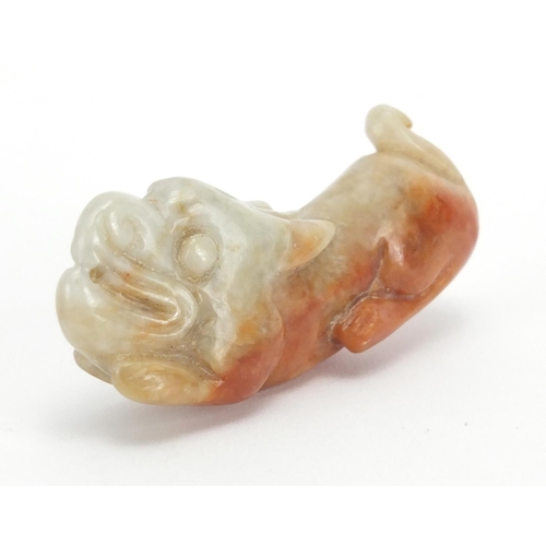 433 - Three Chinese russet and green jade pendants including a pair carved as mythical animals, with cords... 