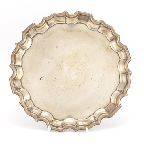 651 - Circular silver three footed salver, indistinct makers mark Birmingham 1911, 21cm in diameter, appro... 