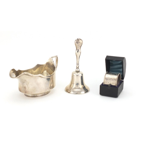 655 - Silver items, sauce boat, hand bell and circular napkin ring with fitted case, various hallmarks, th... 