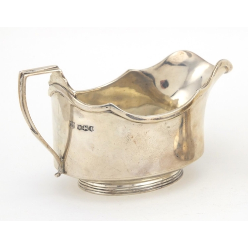 655 - Silver items, sauce boat, hand bell and circular napkin ring with fitted case, various hallmarks, th... 