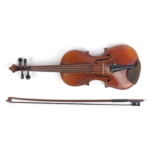 133 - Old wooden violin with scrolled neck, bow and fitted wooden carrying case, the violin bearing a Czec... 