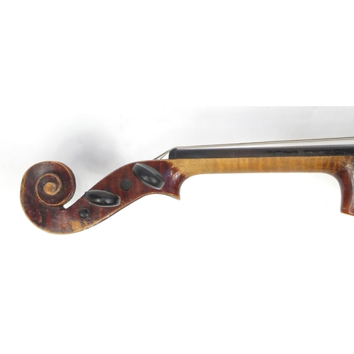 131 - Old wooden violin with scrolled neck, bow and fitted carrying case, the violin bearing a German pape... 