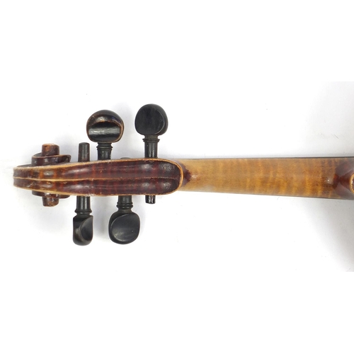 131 - Old wooden violin with scrolled neck, bow and fitted carrying case, the violin bearing a German pape... 