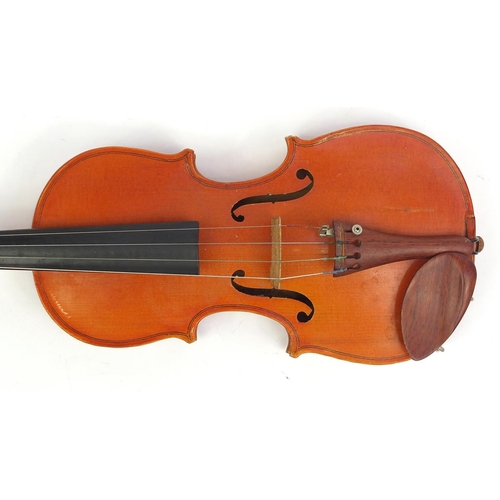 139 - Old wooden violin with scrolled neck, two bows and fitted wooden carrying case, the violin bearing a... 