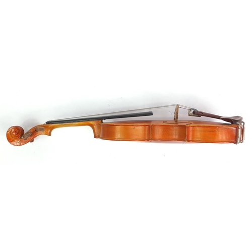 139 - Old wooden violin with scrolled neck, two bows and fitted wooden carrying case, the violin bearing a... 