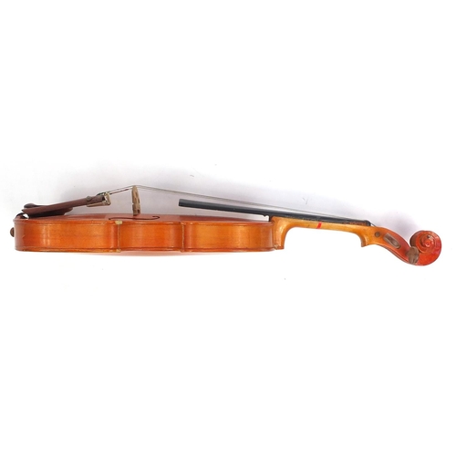 139 - Old wooden violin with scrolled neck, two bows and fitted wooden carrying case, the violin bearing a... 