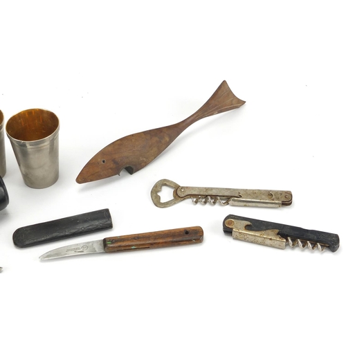 58 - Hunting and fishing objects including wooden fish bottle opener and set of four silver plated travel... 