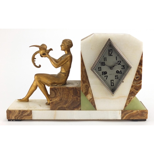 600 - Art Deco marble and onyx mantel clock, signed J Dauvergne, mounted with a female holding a bird, the... 