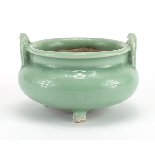 381 - Chinese celadon glazed tripod incense burner with twin handles, 8.5cm high x 12cm in diameter