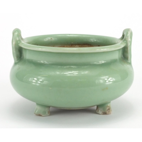 381 - Chinese celadon glazed tripod incense burner with twin handles, 8.5cm high x 12cm in diameter