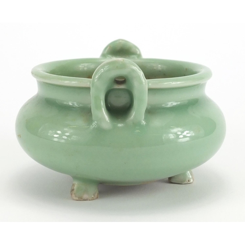 381 - Chinese celadon glazed tripod incense burner with twin handles, 8.5cm high x 12cm in diameter