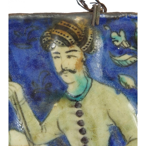 489 - Rectangular Islamic pottery tile hand painted with a figure on horseback, 18cm x 12cm