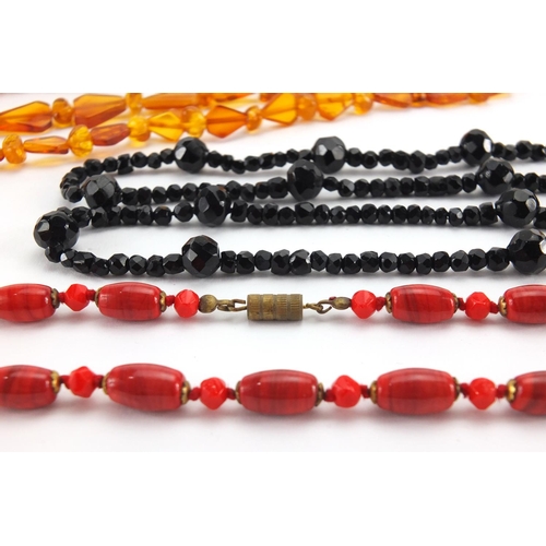 792 - Vintage necklaces including amber, jet and polished stones