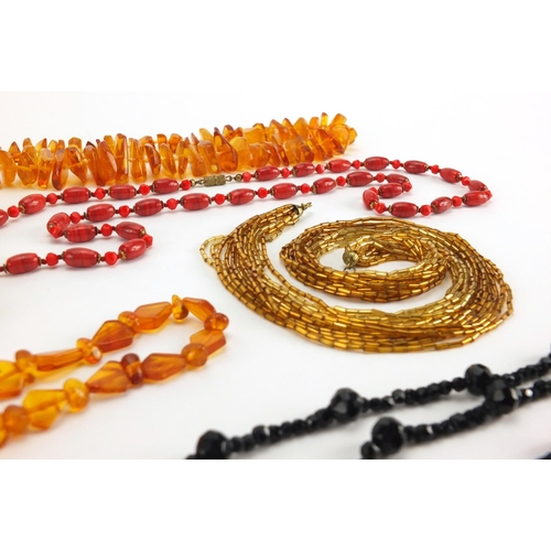 792 - Vintage necklaces including amber, jet and polished stones