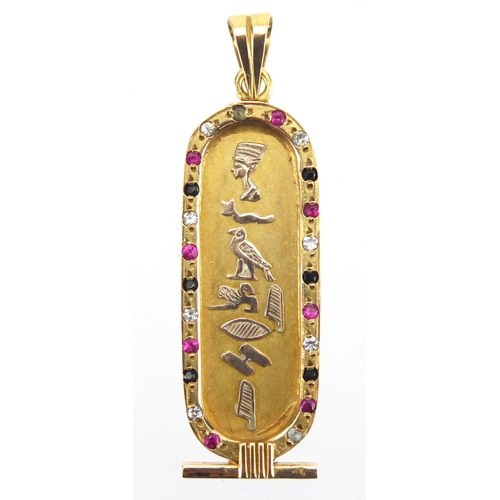 696 - Egyptian gold pendant decorated in relief with hieroglyphics and set with colourful stones, 5.5cm in... 