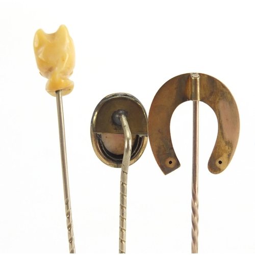 746 - Eight vintage gold and gold coloured metal tie pins including a cameo, horse shoe and pearl examples... 