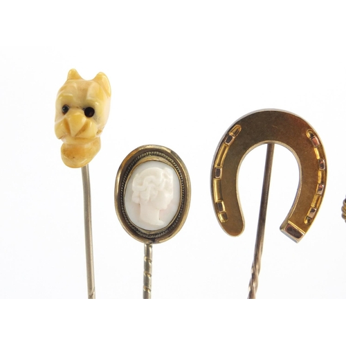 746 - Eight vintage gold and gold coloured metal tie pins including a cameo, horse shoe and pearl examples... 