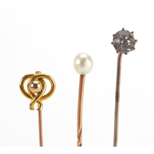 746 - Eight vintage gold and gold coloured metal tie pins including a cameo, horse shoe and pearl examples... 