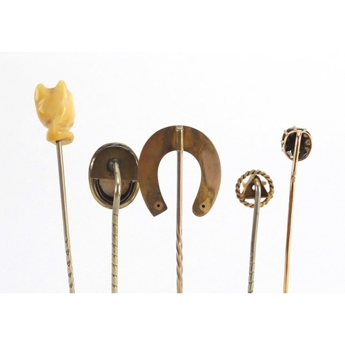 746 - Eight vintage gold and gold coloured metal tie pins including a cameo, horse shoe and pearl examples... 