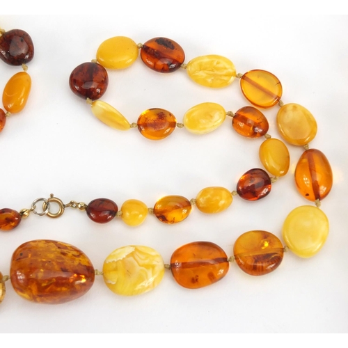 781 - Two butterscotch amber coloured bead necklaces, the largest 70cm in length,  approximate weight 111.... 