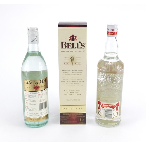 463 - Three bottles of alcohol, 70cl Bells Scotch Whiskey, 75cl Smirnoff Vodka and 75cl Bacardi Rum