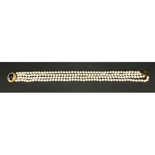 687 - Four row pearl necklace with 9ct gold cabochon garnet clasp, 40cm in length, approximate weight 115.... 