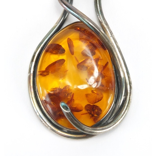 796 - Large unmarked silver and natural amber necklace, the amber 6cm in length, approximate weight 82.4g