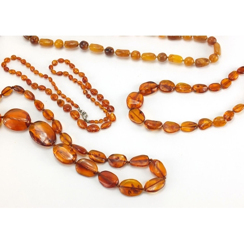 782 - Seven natural and butterscotch amber coloured bead necklaces, the largest 140cm in length, approxima... 