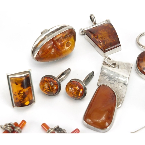 795 - Mostly unmarked silver and natural amber jewellery, including earrings, rings and pendants, the larg... 