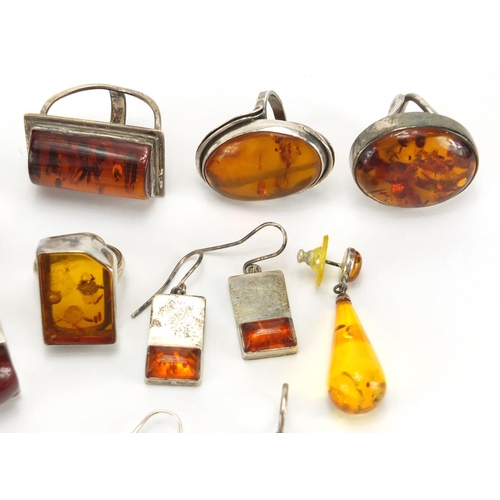 795 - Mostly unmarked silver and natural amber jewellery, including earrings, rings and pendants, the larg... 