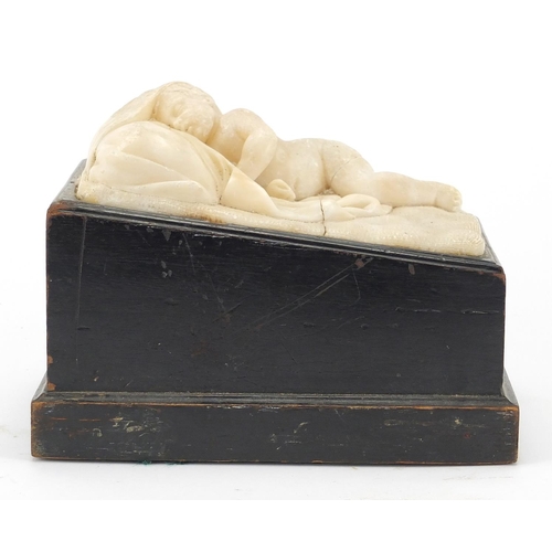 9 - Classical white marble carving of a sleeping nude boy, raising on an ebonised base, 15cm H x 19cm W ... 