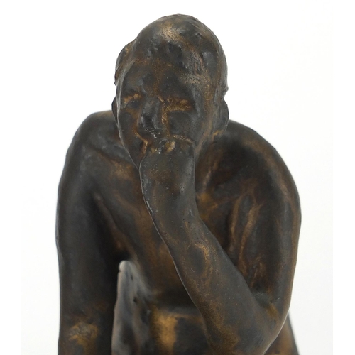 595 - Style of Bernhard Hoetger, two bronzed pottery statues, one of a seated nude male the other of a fat... 