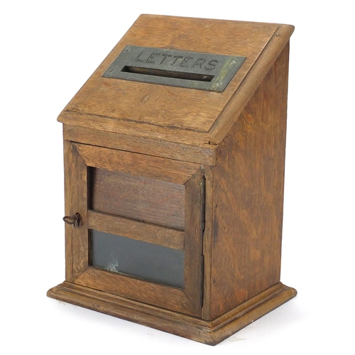 102 - Edwardian oak letter box with hinged front having a brass 'Letters' flap above a glass panel, 30cm h... 