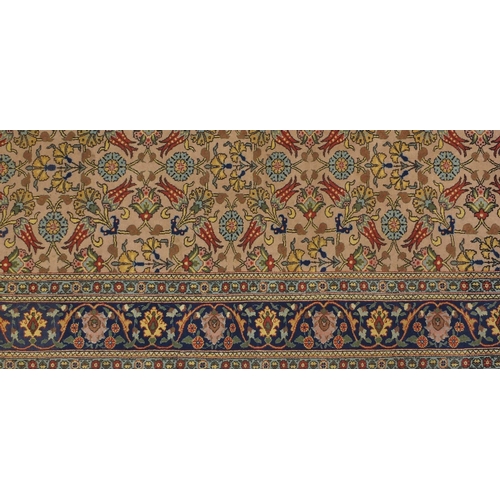2005 - Rectangular Indian rug having and repeat flower head and vine design, approximately 290cm x 208cm